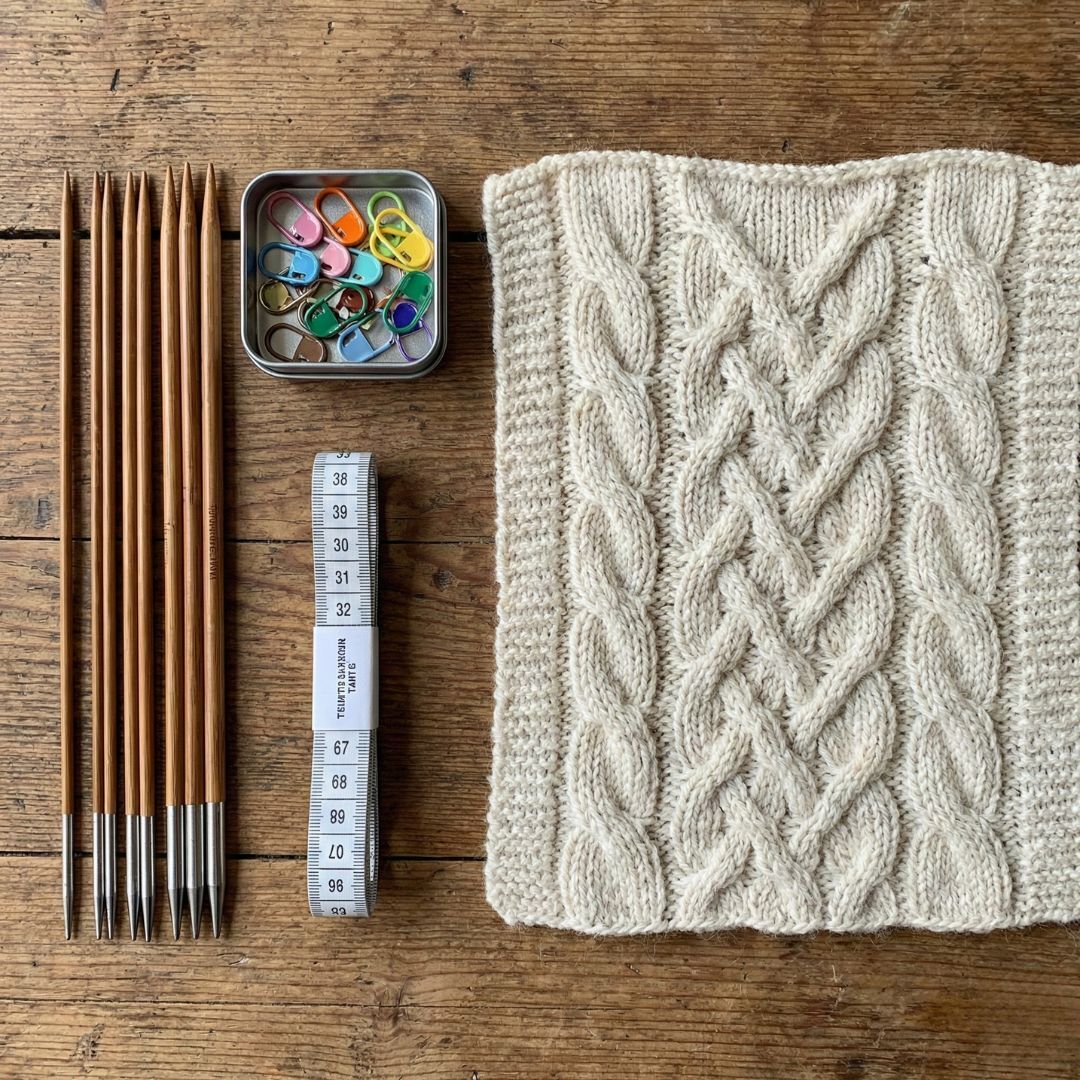 High-quality knitting tools and premium yarn from The Loopy Ewe displayed to show how quality materials aid in precision.